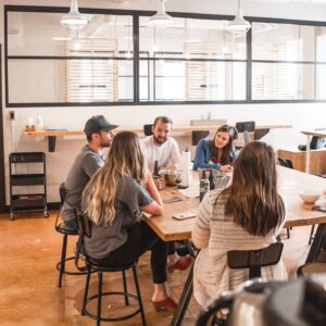 Business to witness group sitting around a table.