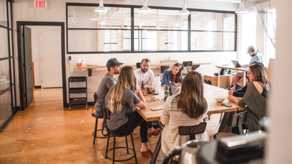 Business to witness group sitting around a table.