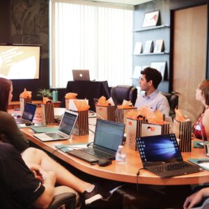 People getting trained in a small boardroom.