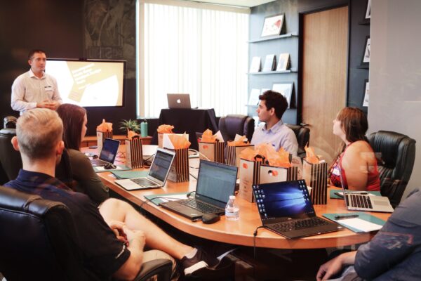 People getting trained in a small boardroom.